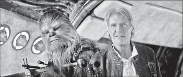  ??  ?? Chewbacca (Mayhew) and Han Solo (Ford) in ‘Star Wars: The Force Awakens’. — Film Frame/ Lucasfilm