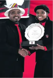  ??  ?? Tim Sukazi hands over the Chairman’s Award to 21-year-old Njabulo Sukazi.