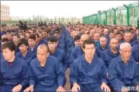  ?? ?? Detainees in a Xinjiang camp in 2017