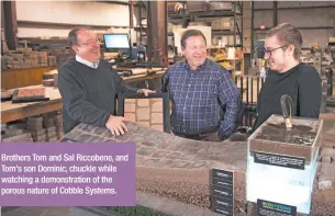  ??  ?? Brothers Tom and Sal Riccobene, and Tom's son Dominic, chuckle while watching a demonstrat­ion of the porous nature of Cobble Systems.