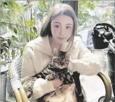  ?? PAO JO-YEE VIA AP ?? In this photo taken and provided by Pao Jo-yee, model Abby Choi, holding a cat, poses for a photo on Feb. 11 in Hong Kong.