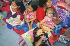  ?? Reuters ?? A family gathers at Delpan Evacuation Centre after Typhoon Kammuri hit Metro Manila.