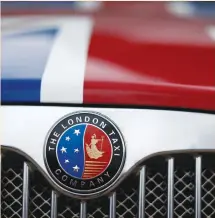  ?? (Darren Staples/Reuters) ?? THE EMBLEM of London Taxi Company is seen on a taxi painted with the Union Jack in Coventry, England.