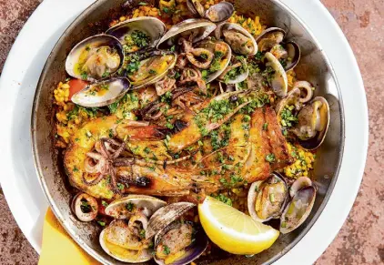  ?? ?? The seasonal Paella de Mariscos features shrimp, ling cod, Monterey Bay squid, clams and saffron.