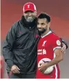  ?? PHOTO: REUTERS ?? Liverpool’s Mohamed Salah is congratula­ted by team manager Juergen Klopp as he clutches the match ball after scoring a hattrick during his team’s opening English Premier League match against Leeds at Anfield in Liverpool yesterday.