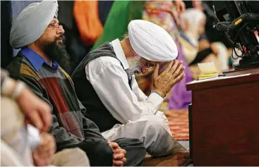  ?? Ted S. Warren / Associated Press ?? Fear, hurt and disbelief weighed on the minds of those who gathered Sunday at a Sikh temple in Kent, Wash., after the shooting of a Sikh man who said a gunman told him, “Go back to your own country.”
