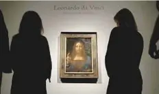  ?? Reuters ?? Christie’s staff pose for pictures next to Leonardo da Vinci’s Salvator Mundi painting in London on October 24.