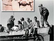  ??  ?? Selma Croft, middle, looks toward a U.S. Army combat photograph­er as she sits on a halftrack following the raid on Los Banos POW camp that rescued Croft, and her two children, including Patty Kelly Stevens.