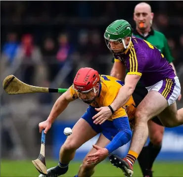  ??  ?? Wexford full-back Darren Byrne giving Clare’s John Conlon precious little room to manoeuvre.