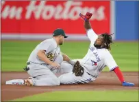  ?? ?? Sheldon Neuse of the Oakland Athletics tags out Vladimir Guerrero Jr. of the Toronto Blue Jays trying to steal second base in the first inning during their MLB game at the Rogers Centre on in Toronto, Ontario, Canada.