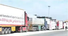  ?? ?? Egyptian trucks containing humanitari­an aid wait to cross the border into Gaza late this month