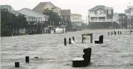  ?? STAFF FILE ?? Yards sit underwater during soundside flooding in 2012 from Hurricane Sandy in Frisco on Hatteras Island on North Carolina’s Outer Banks.