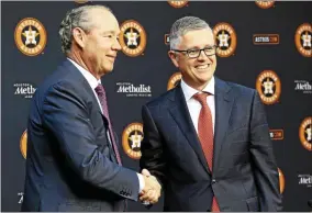  ?? BOB LEVEY - THE ASSOCIATED PRESS ?? Jim Crane, owner and chairman of the Houston Astros, left, shakes hands with Jeff Luhnow in 2018