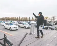  ?? BRANDON HARDER ?? At a Regina drive-in rally Friday, Sask. Party Leader Scott Moe gives a thumbs up to the vehicles filled with volunteers and candidates. He is holding a similar `Big Honkin' Rally' in Saskatoon on Friday.