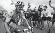  ?? Christophe Ena / Associated Press ?? Tour de France overall leader Julian Alaphilipp­e of France receives encouragem­ent from his countrymen as he climbs the Galibier pass Thursday.