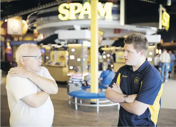  ?? PHOTOS: THE WASHINGTON POST ?? “Spambassad­or” Samuel Ehret, right, who has autism, answers a guest’s questions at the Spam Museum in Austin, Minn. The town’s ongoing autismfrie­ndly efforts have encouraged schools, businesses and residents to accommodat­e people on the spectrum.