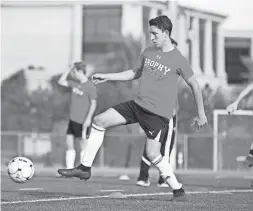  ??  ?? Brophy Prep midfielder Francesco Montanile runs a drill during practice in Phoenix on Wednesday.