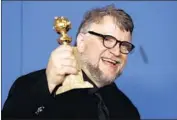  ??  ?? DIRECTOR and co-writer Guillermo del Toro of “The Shape of Water” with his directing award.