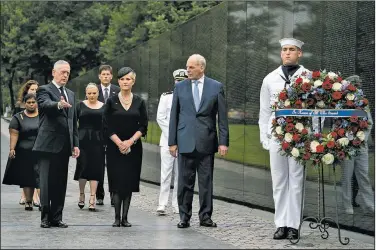  ?? AP/ANDREW HARNIK ?? Cindy McCain, John McCain’s widow, prepares to help place a wreath at the Vietnam Veterans Memorial on Saturday in Washington. Defense Secretary James Mattis (left), White House Chief of Staff John Kelly (second from right) and McCain family members join in the ceremony.