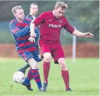  ??  ?? A tussle for possession between FC Menzieshil­l (maroon) and Ferry Mechanics.