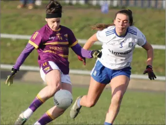  ??  ?? Caitríona Murray takes aim as Monaghan defender Sarah Boyd arrives too late to challenge.