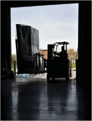  ?? READE PICKERT — BLOOMBERG, FILE ?? A worker uses a forklift to move packages at a facility in Baltimore in 2017.
