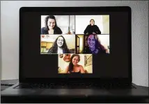  ??  ?? Jackie Mostney (middle right) holds up a lit candle as she speaks during a virtual Rosh Chodesh gathering Sept. 5. The women who attended live across the United States and Israel. Rosh Chodesh is Hebrew for “new month” or “head of the month.”