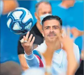  ??  ?? Jack Grealish hands fans signed footballs at the Etihad Stadium during his unveiling.