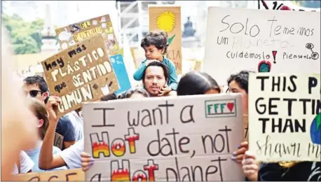  ?? RODRIGO ARANGUA/AFP ?? People march along Reforma Avenue in Mexico City on September 20 as part of the ‘Friday for the Planet’ global demonstrat­ion against climate change.