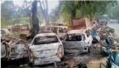  ?? —PTI ?? The charred vehicles which were set on fire by a mob over the alleged slaughter of cattle, in Bulandshah­r.