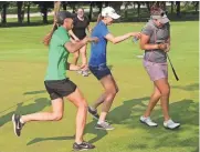  ?? JOHN KLEIN / FOR THE MILWAUKEE JOURNAL SENTINEL ?? Brittany Marchand (right) gets doused with water after winning the PHC Classic on Sunday at Brown Deer Park Golf Course for her first win on the Symetra Tour.