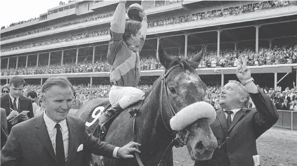  ?? THE ASSOCIATED PRESS FILES ?? Jockey Bob Ussery, owner Peter Fuller, left, and trainer Louis C. Cavalaris Jr. celebrate with Dancer’s Image in May 1968.