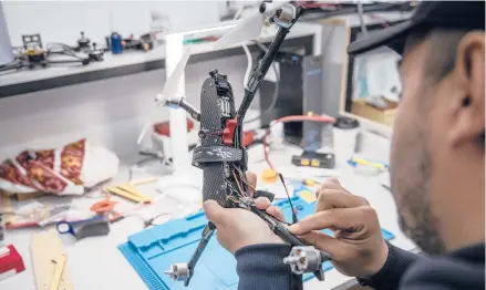  ?? FINBARR O’REILLY/THE NEW YORK TIMES ?? A technician modifies a racing drone at a workshop supporting the Ukrainian military on April 19 in western Ukraine.