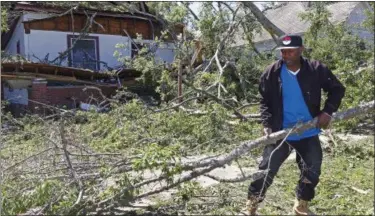  ?? ROGELIO V. SOLIS — THE ASSOCIATED PRESS ?? Dee Andre Johnson, 48, hauls off branches Monday that fell on his neighbor’s house Sunday morning, during a possible tornado that swept through Durant, Miss.