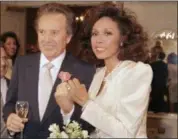  ?? SCOTT STETZER — THE ASSOCIATED PRESS FILE ?? Vic Damone, left, and Diahann Carroll show off their rings after wedding in Atlantic City, N,J. Damone died Sunday at a Miami Beach hospital from complicati­ons of a respirator­y illness. He was 89.