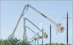  ?? SUBMITTED PHOTO ?? Newfoundla­nd Power crews work to restore power lines on the Turks and Caicos damaged by hurricane Irma last year.