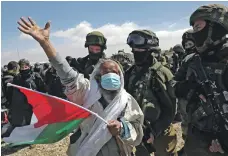  ?? AFP ?? Soldiers disperse Palestinia­n and Israeli activists trying to block Route 60, the main road for West Bank Jewish settlement­s