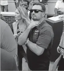  ?? [STEVE SISNEY, THE OKLAHOMAN ARCHIVES] ?? Former OU head coach Bob Stoops and wife Carol wait at the end zone following the Sooners' win against UCLA last season in Norman.