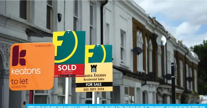  ?? — AFP ?? LONDON: Estate and rental agents’ boards are pictured on a residentia­l street in Hackney, east London on Friday. House prices and sales are “losing momentum”, surveyors say amid fears that Britain’s economy is on the verge of a recession.