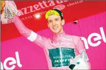  ??  ?? Britain’s rider of Team Mitchelton-Scott Simon Yates celebrates the pink jersey of the overall leader on the podium after the 10th stage between Penne and Gualdo Tadino during the 101st Giro d’Italia, Tour of Italy cycling race, on May 15. (AFP)