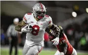  ?? NICK WASS / AP ?? Ohio State tight end Cade Stover (8) runs with the ball past Maryland linebacker Ruben Hyppolite II (11) during the second half of their game on Nov. 19, 2022. Stove was a team captain last season and figures to be one again in 2023.