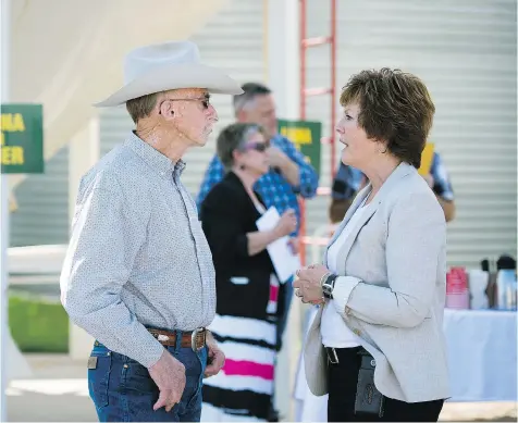  ?? TROY FLEECE ?? Retired rancher Murray McGillivar­y, left, speaks with Alanna Koch just before she announced her plans to run for the Saskatchew­an Party leadership on a farm just south of Regina on Monday. Koch has most recently served as deputy minister to the premier.