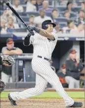  ?? Frank Franklin II / Associated Press ?? New York’s Aaron Hicks hits his 25th homer of the season, a two-run shot in the fourth inning on Friday. Hicks also scored four runs.