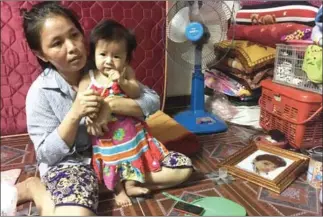  ?? ERIN HANDLEY ?? Sok Noeun, 36, sits with her 7-month-old daughter at her house in Phnom Penh’s Meanchey district.