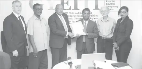  ??  ?? Minister of Natural Resources Raphael Trotman (third from left) submits Guyana’s applicatio­n for membership to the Extractive Industries Transparen­cy Initiative (EITI). Receiving the applicatio­n on behalf of the EITI is the National Coordinato­r of the...