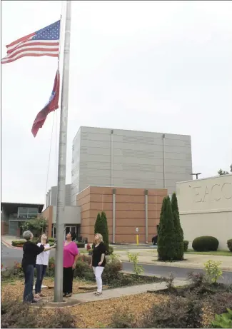  ?? Brodie Johnson • Times-Herald ?? Willie Smith, Chairman of the East Arkansas Community College Board of Trustees, passed away on Thursday, July 1. From left, Michelle Wilson, Lindsay Midkiff, Niki Jones and Anne Kelso lower the flag on campus in honor of Smith.