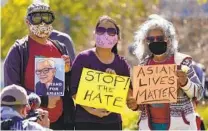  ?? DAMIAN DOVARGANES AP FILE ?? A man holds a portrait of 84-year-old Vichar Ratanapakd­ee, who was violently shoved to the ground in a deadly attack in San Francisco, during a rally last month in Los Angeles.