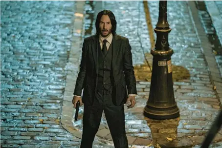  ?? LIONSGATE ?? Keanu Reeves eyes the 222-step Sacre Coeur stairway to punishment in “John Wick 4.”