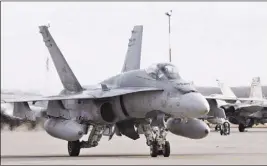  ?? CP PHOTO ?? A pilot positions a CF-18 Hornet at CFB Cold Lake in Alberta. Federal officials are expected to sit down with different fighter jet manufactur­ers in Paris next week.