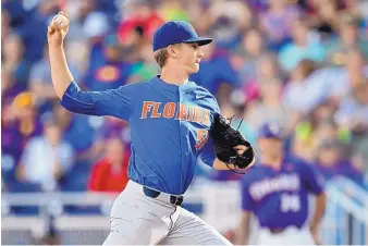  ?? MATT RYERSON/ASSOCIATED PRESS ?? Florida pitcher Brady Singer struck out 12 in seven innings to help the Gators defeat LSU 4-3 in the first game of the College World Series on Monday.